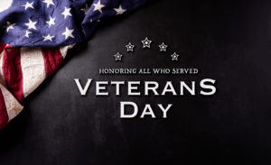 Happy Veterans Day concept. Vintage american flags against black  stone  background. November 11.